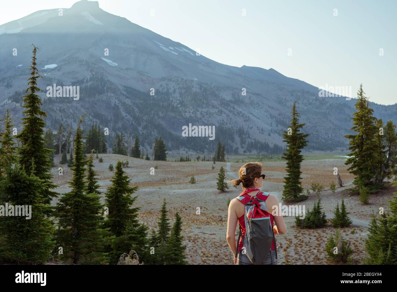Woman looking at mountain during hike in the summer Stock Photo - Alamy