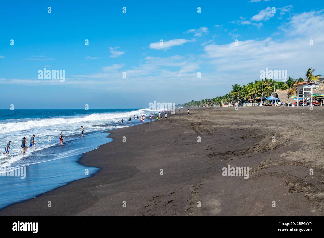 People enjoying the surf and sand at  Monterrico Beach, Guatemala Stock Photo