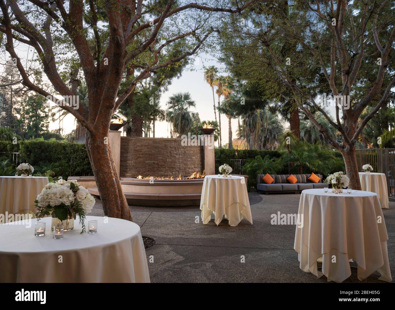 Tables dressed with linen in outdoor space for a reception Stock Photo