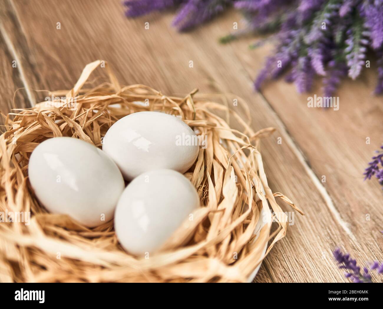 White Easter eggs in the nest. Happy Easter Concept. Congratulations Easter card. Stock Photo