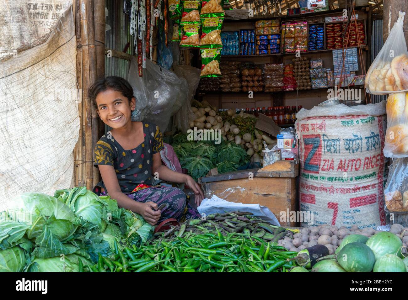 Girl attending to a small shop in a Fishing Village North of Cox's Bazar Stock Photo