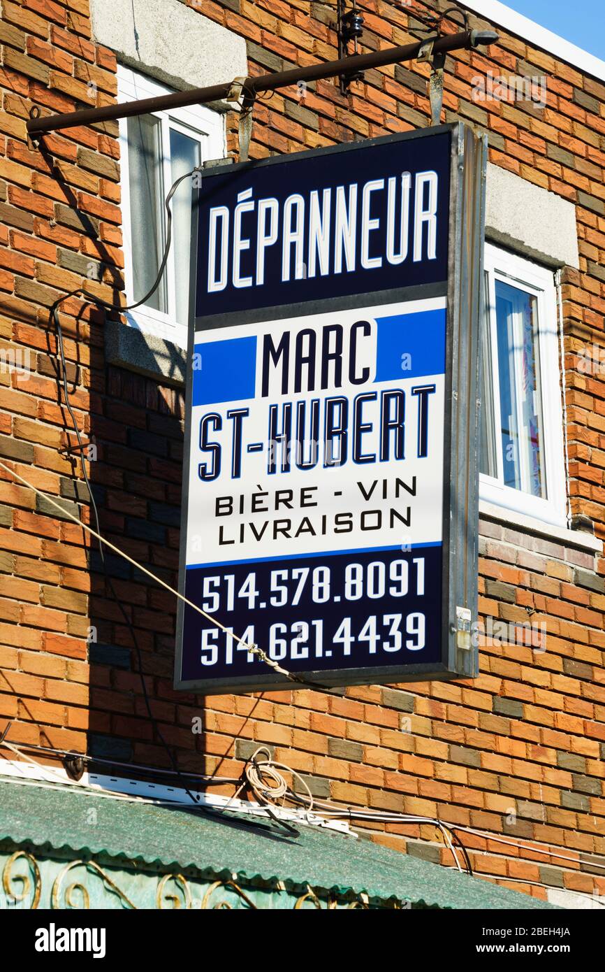 Hanging sign for a dépanneur (convenience store) in Laval, province of Quebec, Canda. Stock Photo