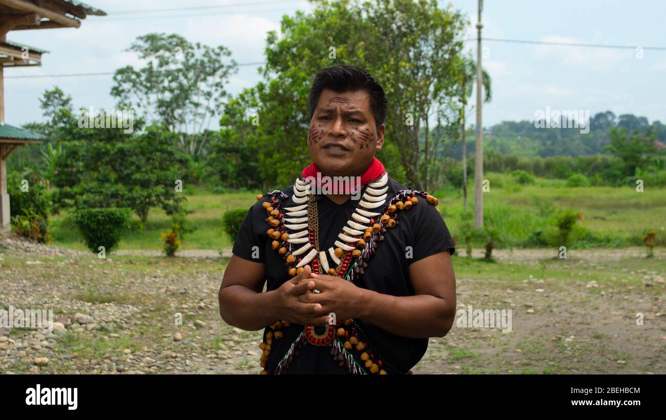 Lago Agrio, Sucumbios / Ecuador - February 20 2020: Cofan ethnic man talking in traditional clothing in the Cofan Dureno millennium community located Stock Photo