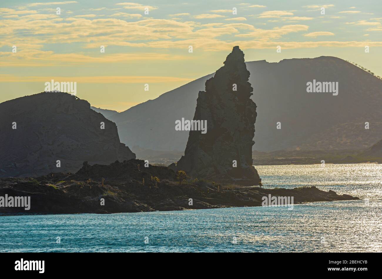 Silhouette of Pinnacle Rock at sunset on Isla Bartolome, Galapagos Islands national park, Ecuador. Stock Photo