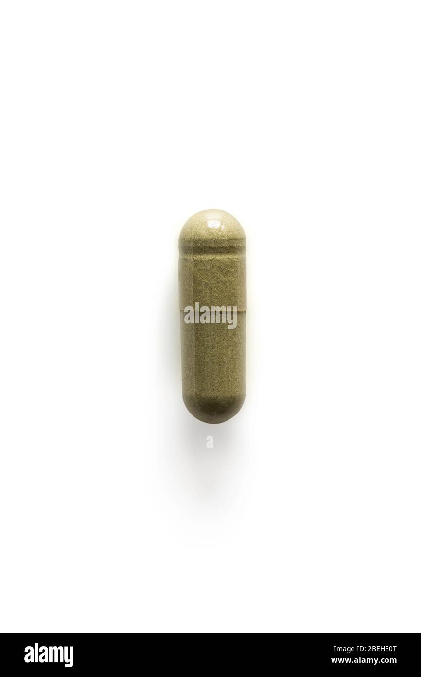 Andrographis paniculata pill capsule in green on white background with clipping path and copy space. Alternative medical from herb for treatment coron Stock Photo