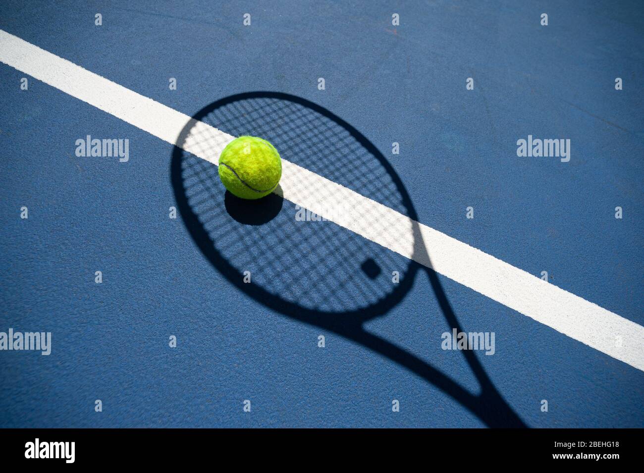 The shadow of the tennis racket and the tennis ball inside it. All on a