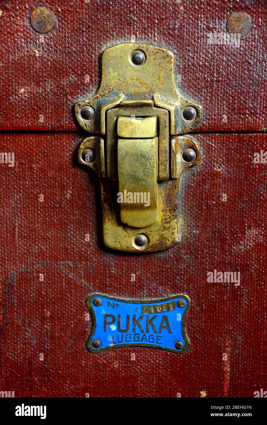Detail of a  drawbolt on an old steamer trunk with the word pukka below it. Stock Photo