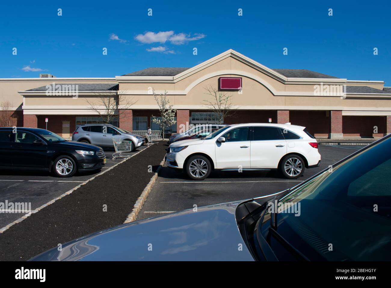 Few shoppers are found in an otherwise busy strip mall in Marlboro, New Jersey, on Monday, April 6th, 2020, due to Covid-19 restrictions -02 Stock Photo