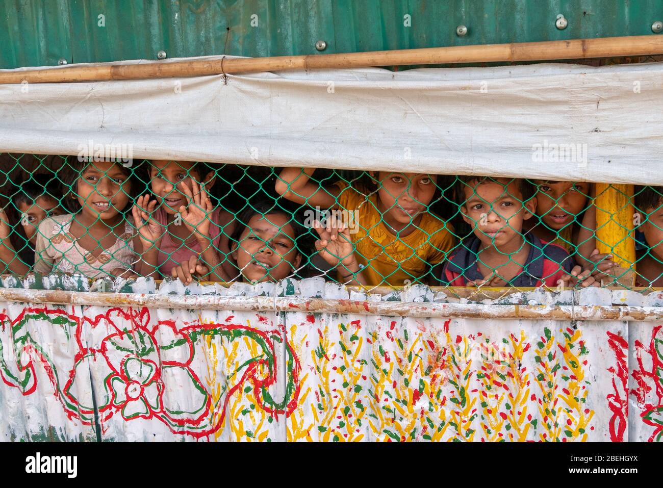 Rohingya Children Behind Wiring at Shool in a Refugee Camp, South of Cox's Bazar near the border with Myanmar. Stock Photo