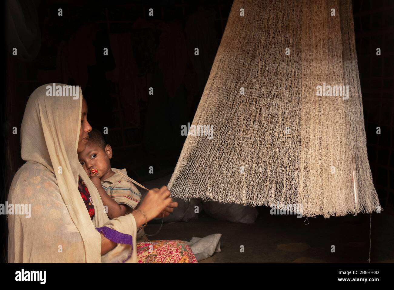 Rohingya Mother Holding Child in a Refugee Camp, South of Cox's Bazar near the border with Myanmar. Stock Photo