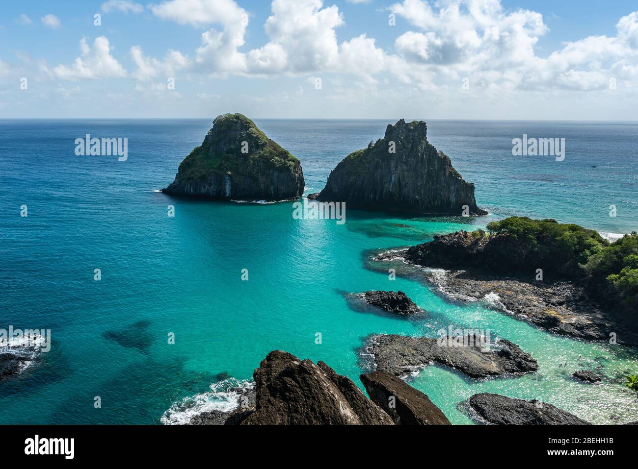 Aerial view of Dois Irmaos Hill at Baia dos Porcos beach, with turquoise clear water, at Fernando de Noronha Marine National Park, a Unesco World Heri Stock Photo