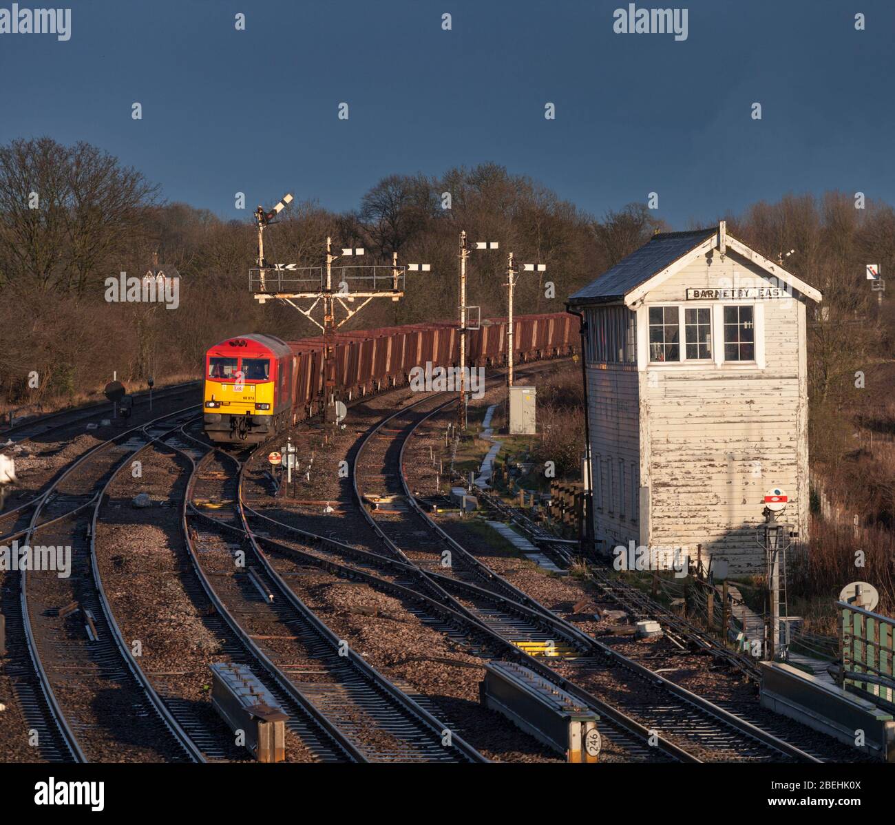 DB cargo Rail UK class 60 locomotives passing the semaphore bracket railway signals and mechanical signal box at Barnetby east with a freight train Stock Photo