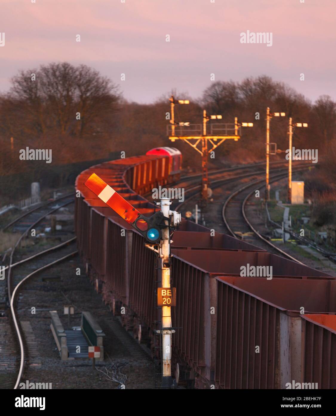 Freight train passing a upper quadrant mechanical semaphore home signal at Barnetby East with a bracket signal behind. Stock Photo