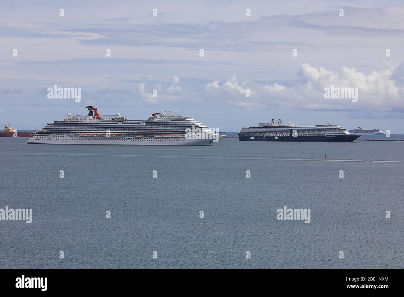 empty cruise ships moored off shore due to the shutdown of non-essential travel during the 2020 coronavirus pandemic .long beach calfornia, Stock Photo