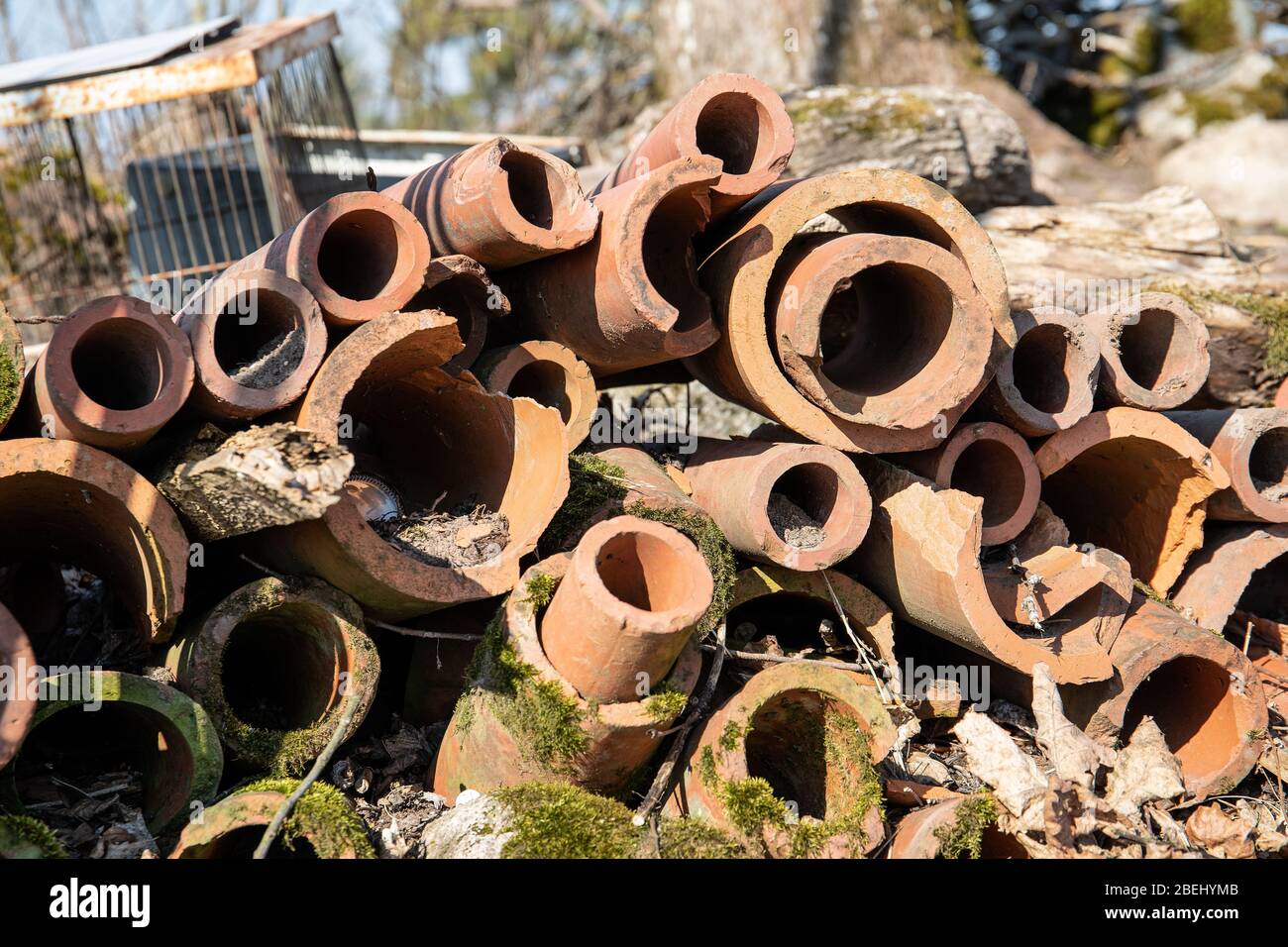 Clay water pipes. Polluted environment, waste and surroundings cleaning