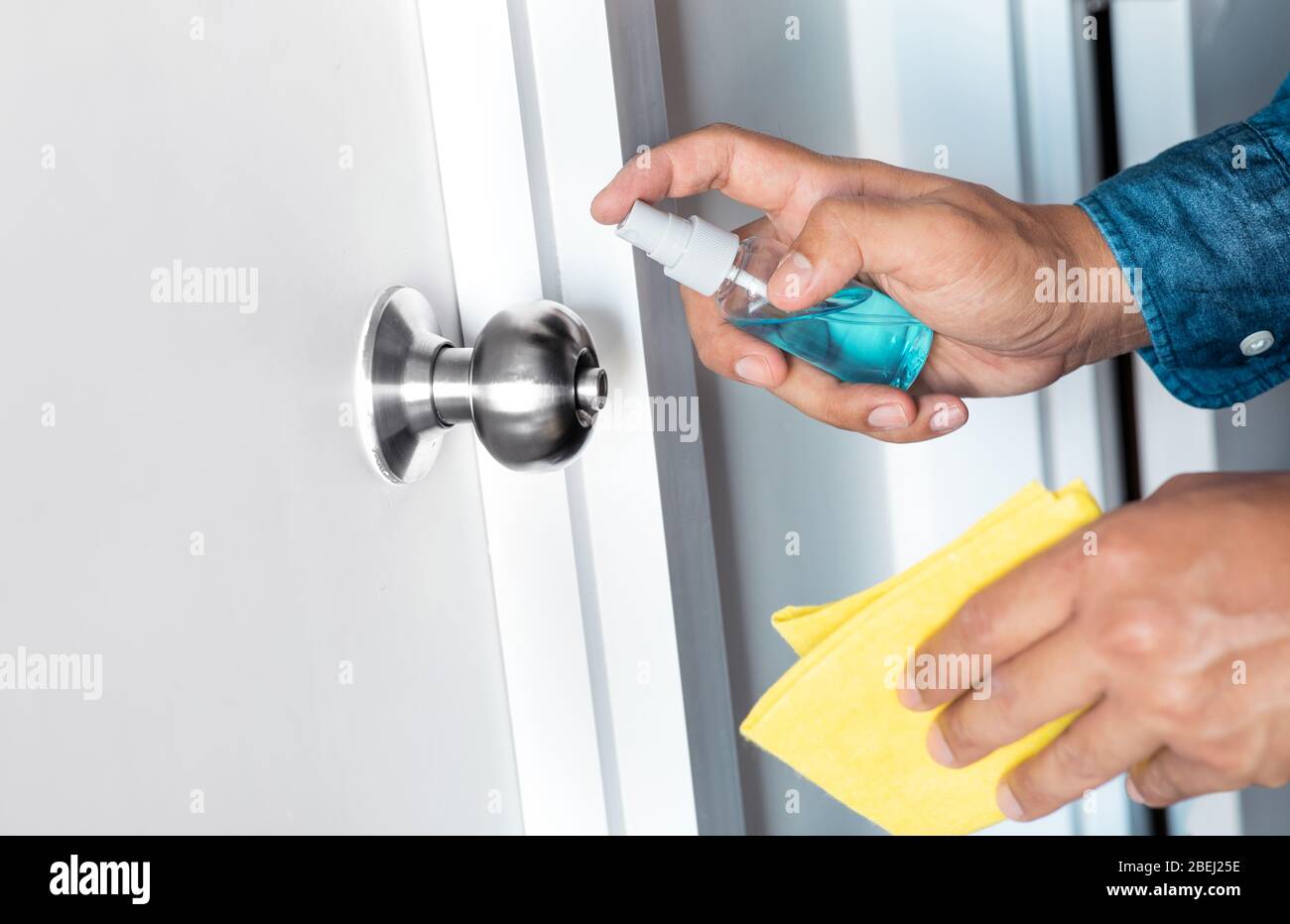Prevention concepts on coronavirus ( covid-19 ) outbreak situation with person cleaning doorknob by alcohol.body health care.protect yourself.healthy Stock Photo