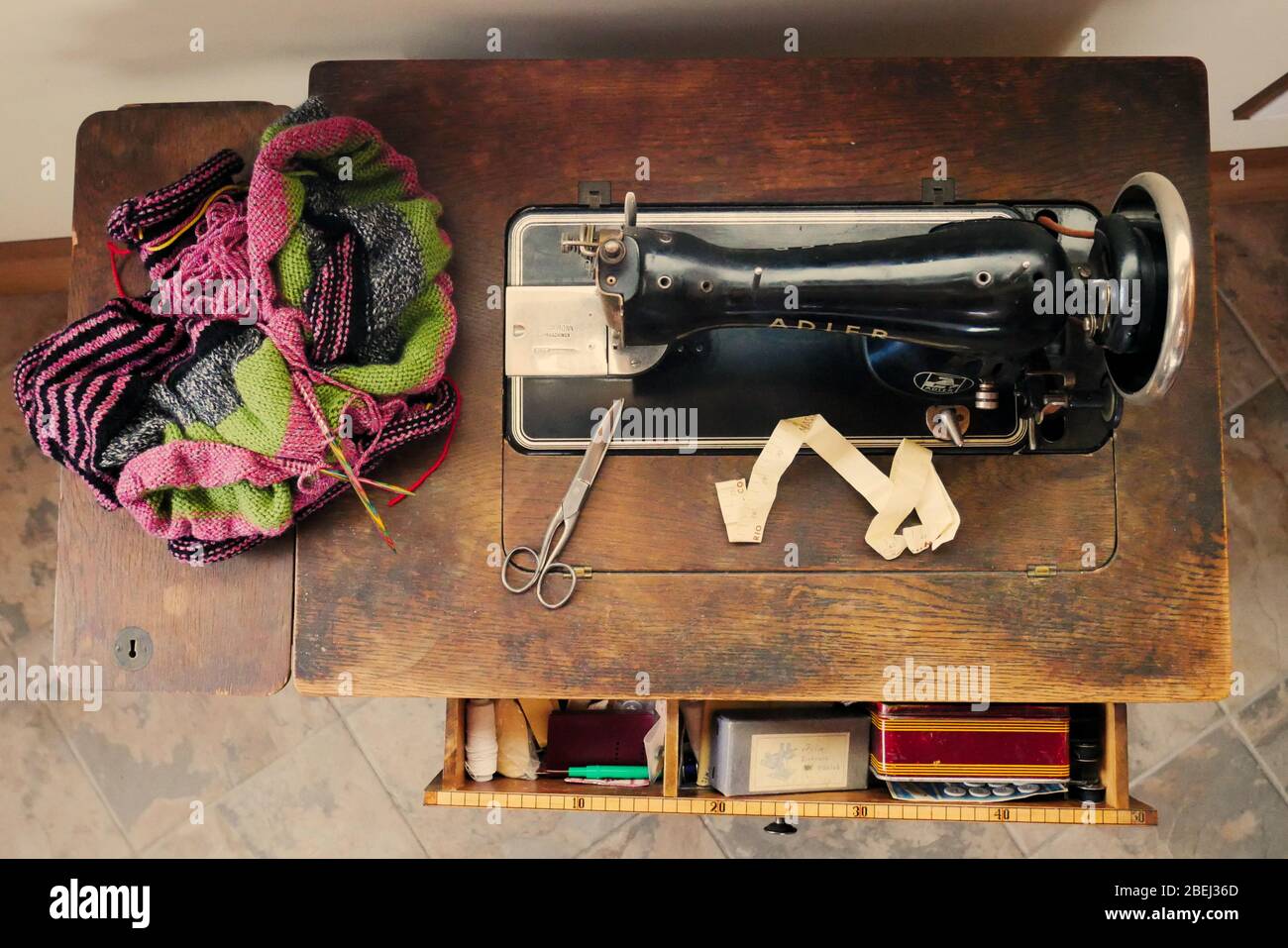 A Brother KH860 Knitting Machine with row counter, punch card, carriage and  attached sinker plate on a bed of knitting needles Stock Photo - Alamy