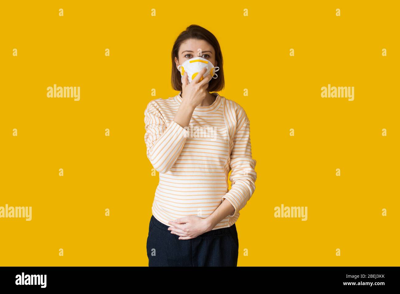 Download Pregnant Caucasian Woman With A Medical Mask On Face Posing On A Yellow Studio Background Stock Photo Alamy PSD Mockup Templates