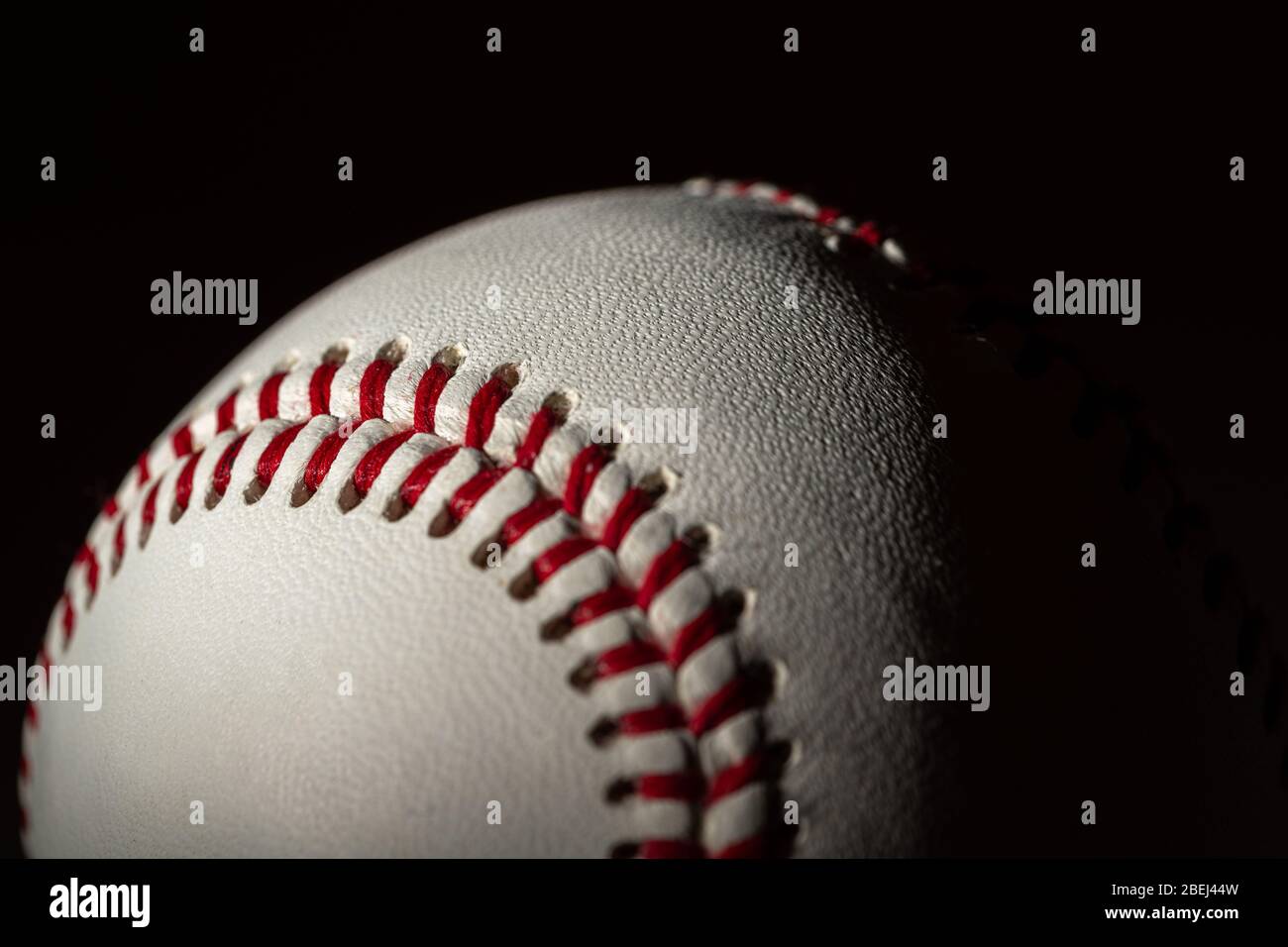 A white leather baseball on a black background Stock Photo