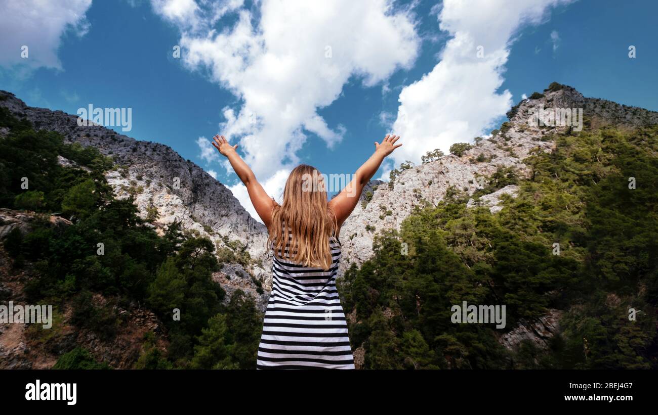 Face Less Freedom Happy blonde girl faceless look at mountain with hands up. Lifestyle ...