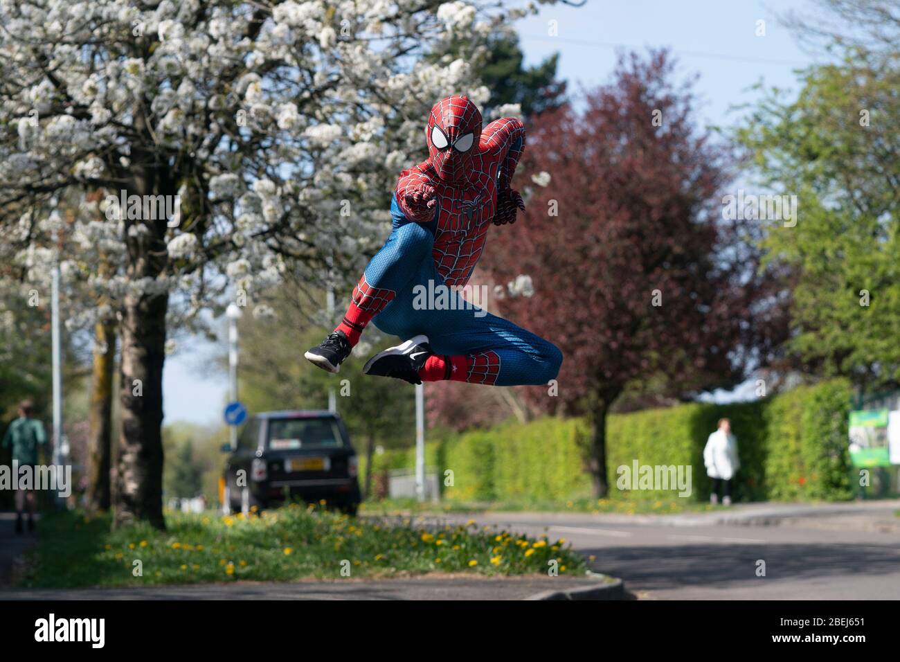 Manchester, COVID-19 outbreak in Manchester. 13th Apr, 2020. Jason Baird, who runs a martial arts academy in South Manchester, dressed up as Spider-Man, entertains the public amid the COVID-19 outbreak in Manchester, Britain on April 13, 2020. Credit: Jon Super/Xinhua/Alamy Live News Stock Photo
