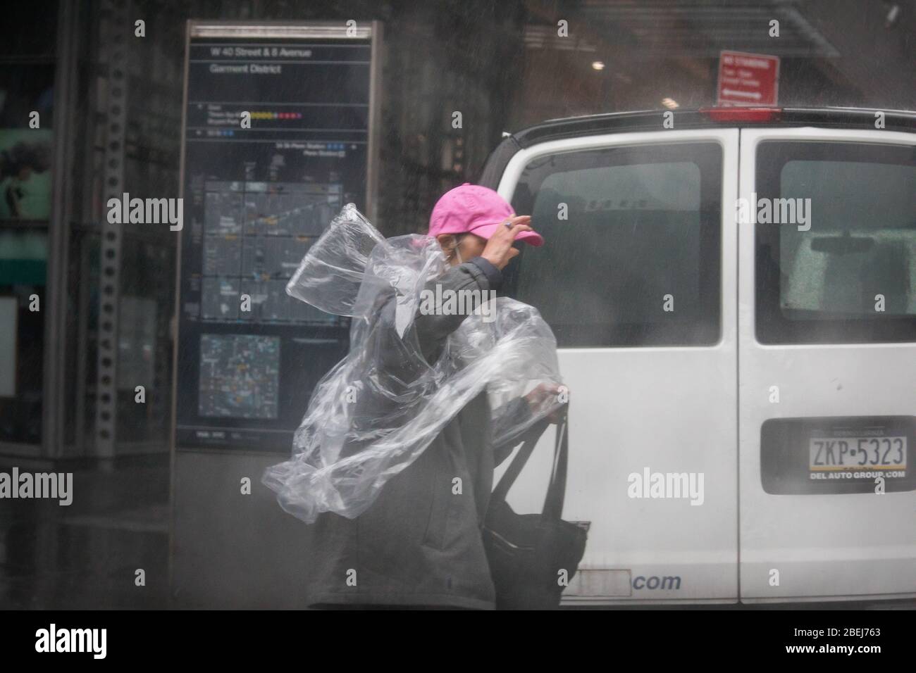 New York, USA. 13th Apr, 2020. A pedestrian wearing a plastic raincoat walks against the wind at the Times Square neighborhood in New York, the United States, April 13, 2020. Strong wind and rain hit New York on Monday. Credit: Michael Nagle/Xinhua/Alamy Live News Stock Photo