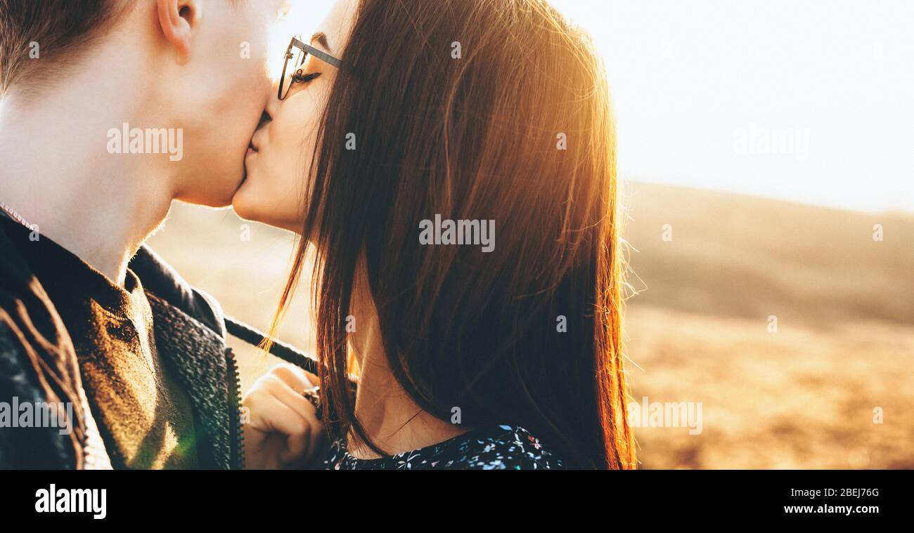 Side view of a couple smiling to each other on a sunny day. 