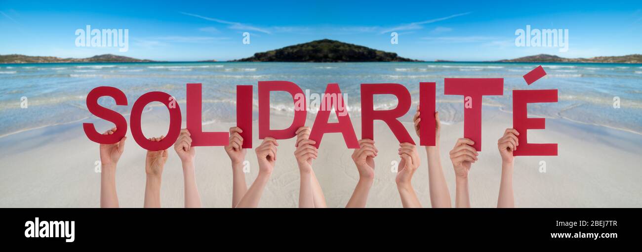 People Hands Holding Word Solidarite Means Solidarity, Ocean Background Stock Photo