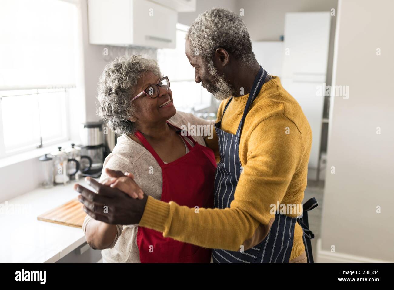 A senior African American couple dancing in the kitchen Stock Photo - Alamy