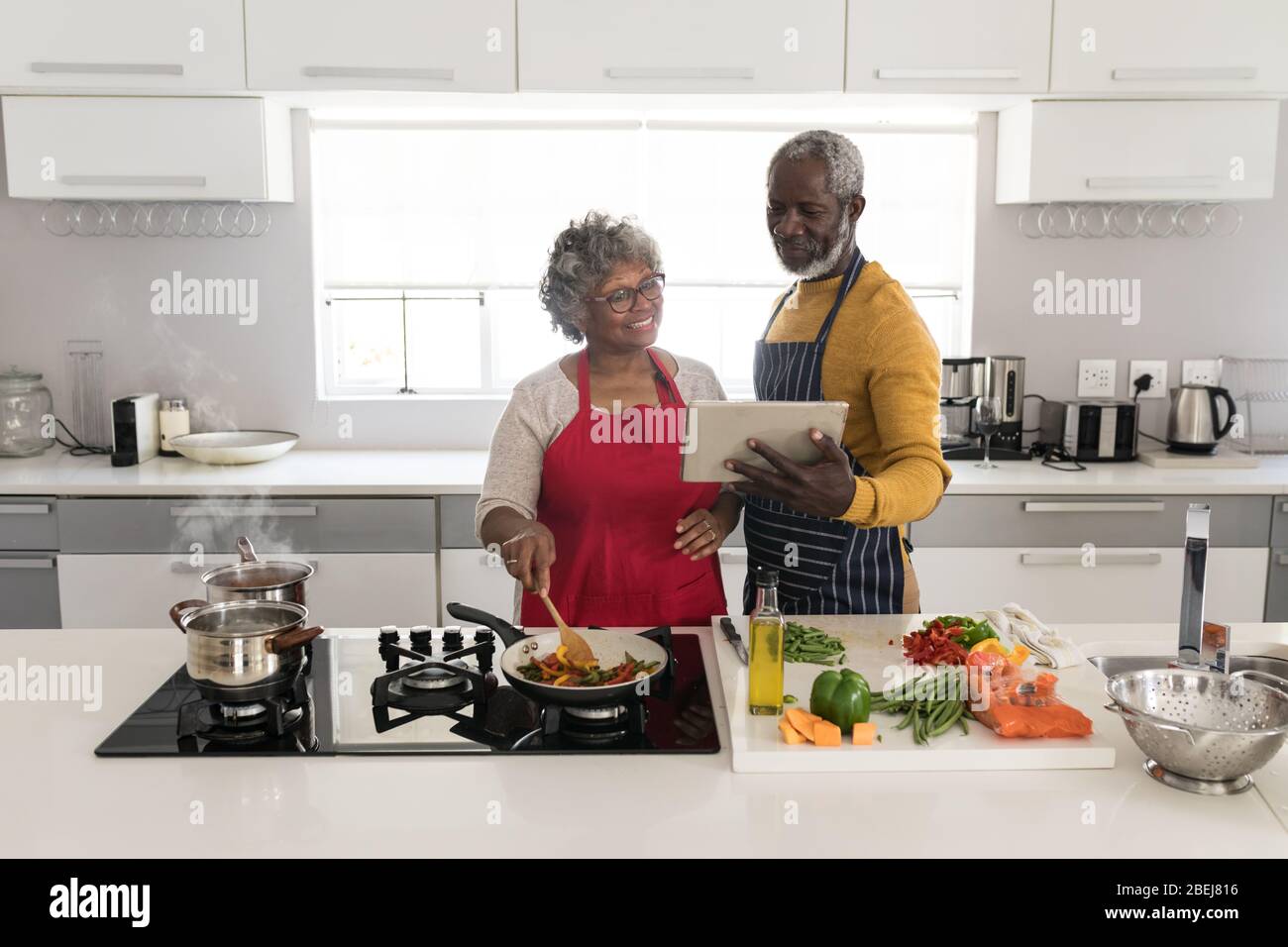 A senior African American couple cooking together Stock Photo - Alamy