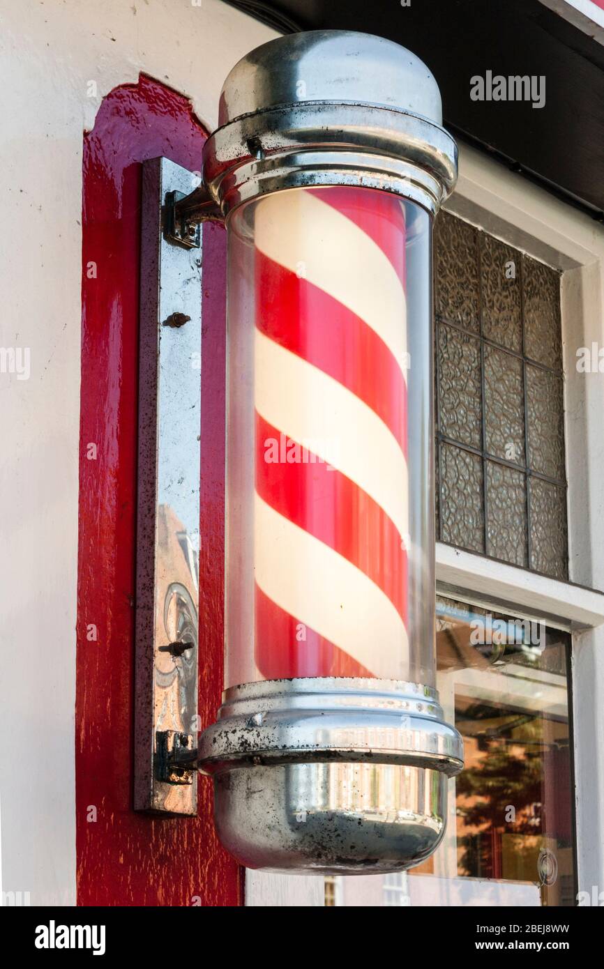 Traditional rotating red and white barbers pole. Stock Photo