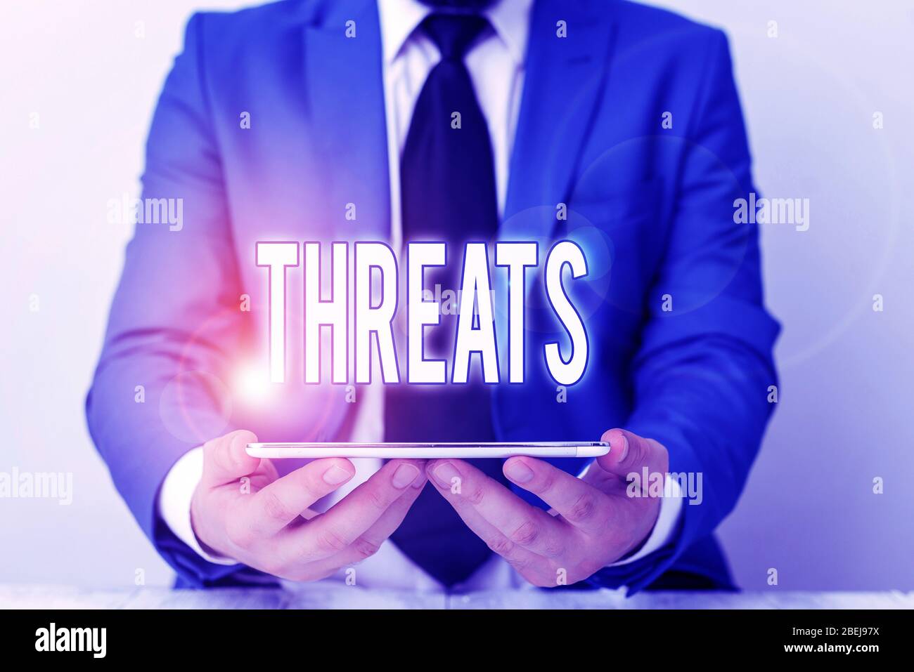 Word writing text Threats. Business photo showcasing Statement of an intention to inflict pain hostile action on someone Businessman in blue suite wit Stock Photo