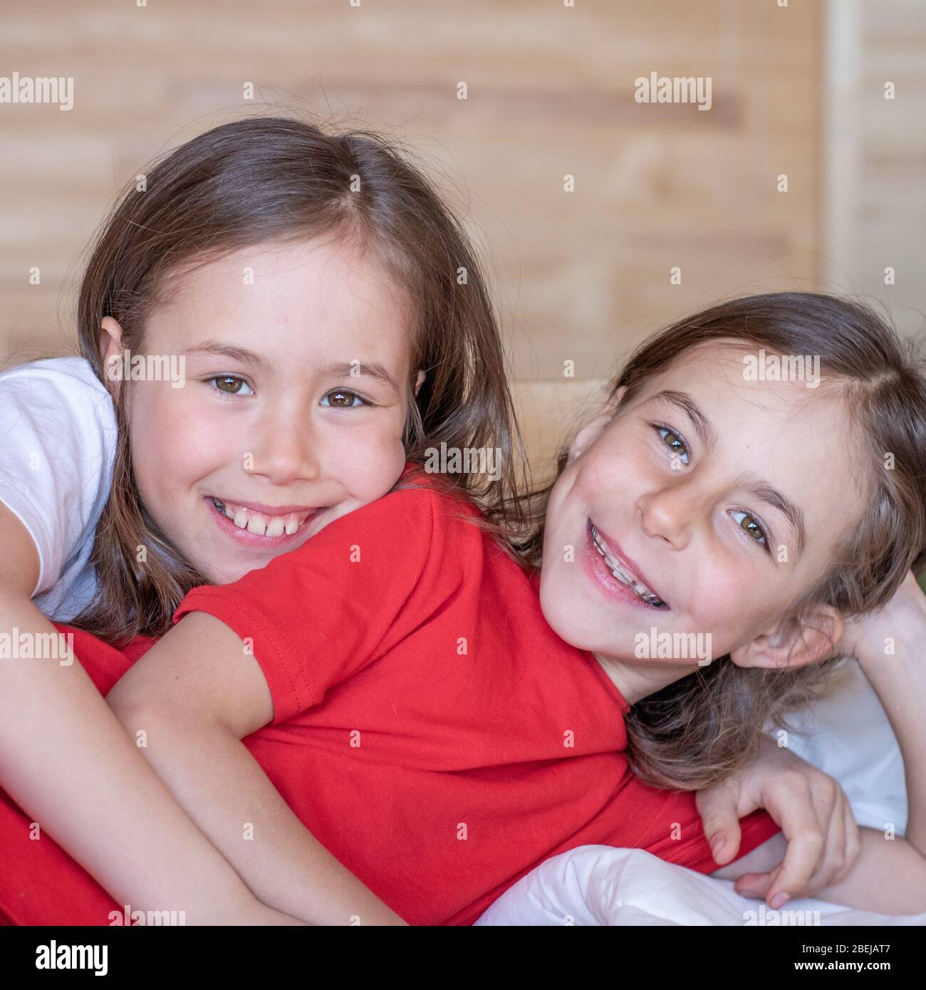 The children woke up early in the morning in their beds. pajama party Stock Photo