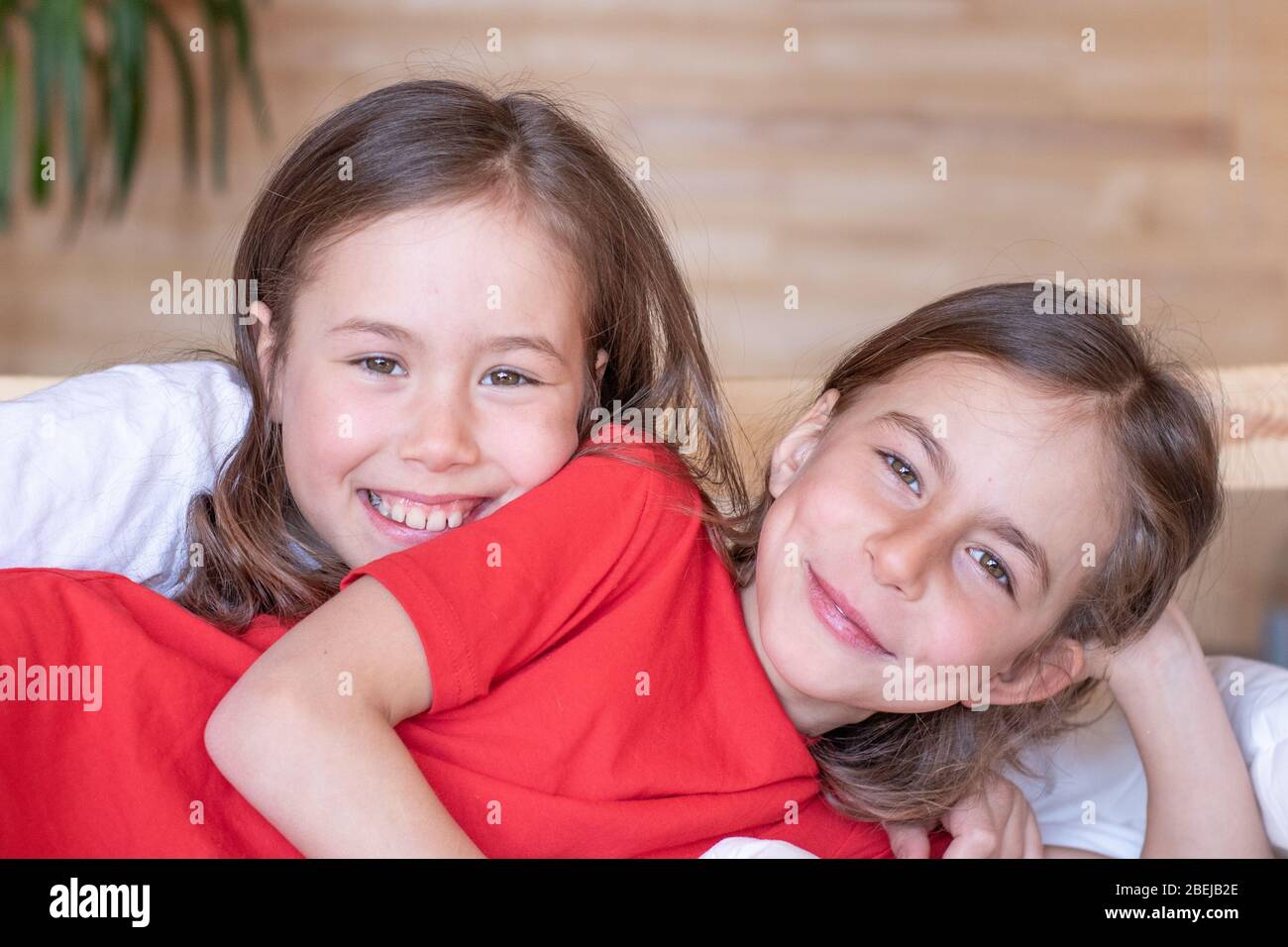 The children woke up early in the morning in their beds. pajama party Stock Photo