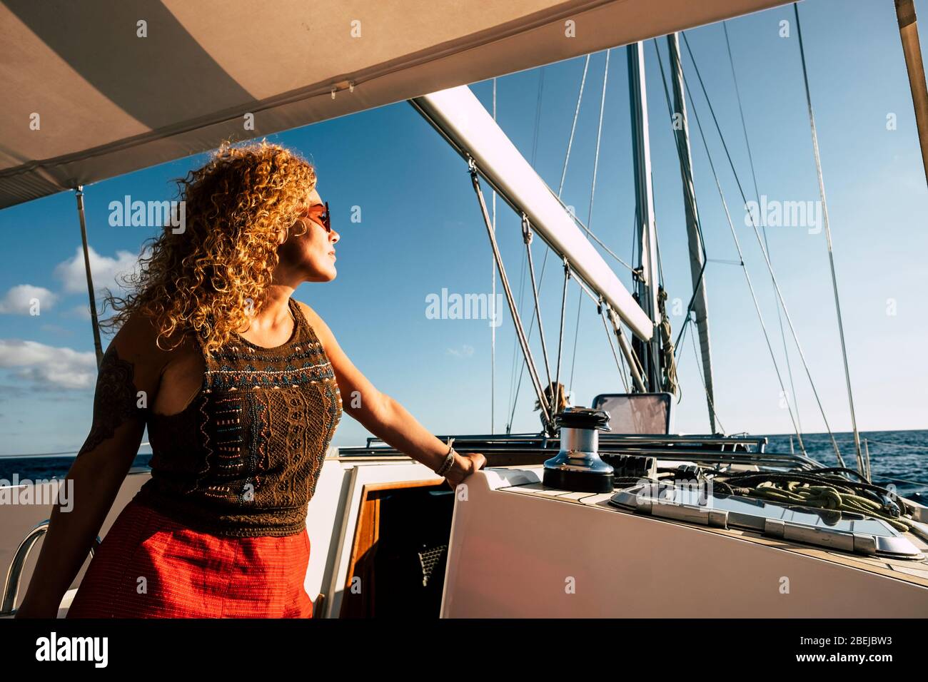 Happy caucasian woman enjoy tourism transport in sail boat -  luxury lifestyle people vacation in summer season on yeacht - people and freedom concept Stock Photo