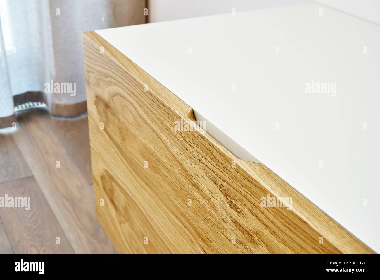 Contemporary floating media cabinet in living room. Wooden wall mounted cabinet Stock Photo