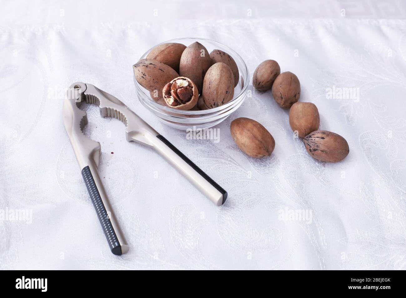 some pecan nuts and nutcracker Stock Photo