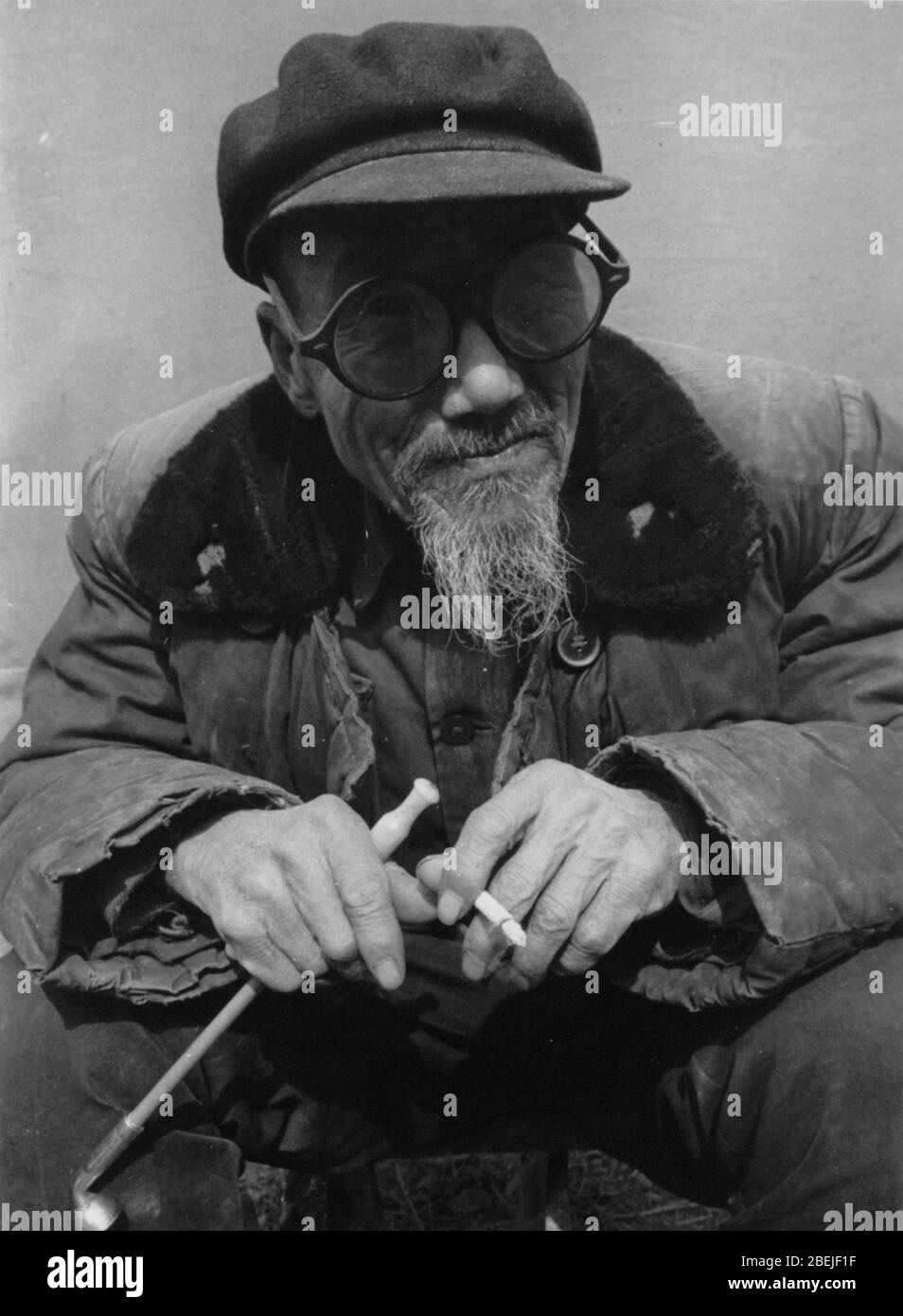 Old man smoking a cigarette Stock Photo