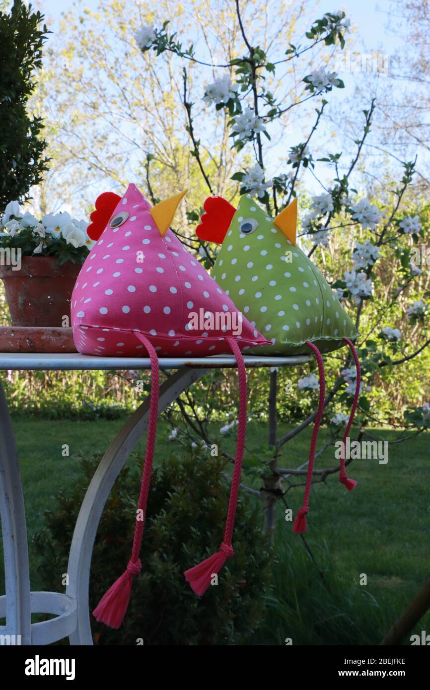 Handcrafted Easter decoration. Two chicken pillows. Homemade. Stock Photo