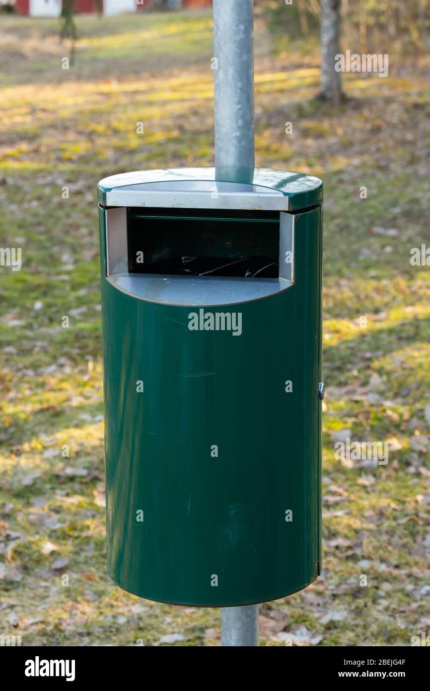 Green metal trash can in a park in Finland Stock Photo - Alamy