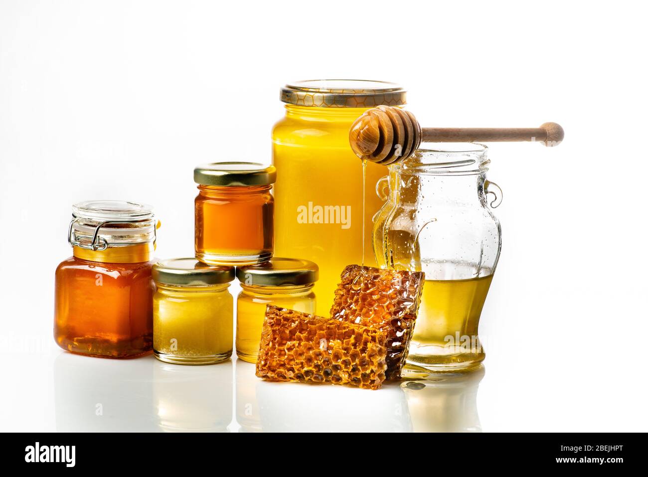 Various types of honey in honey jars for sale on a market stall