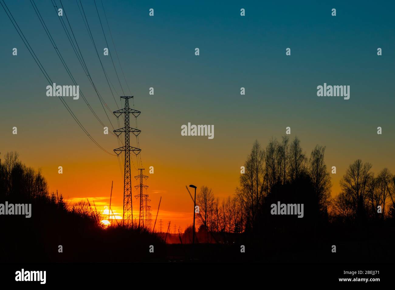 High voltage towers aganist the beautiful sunset Stock Photo - Alamy
