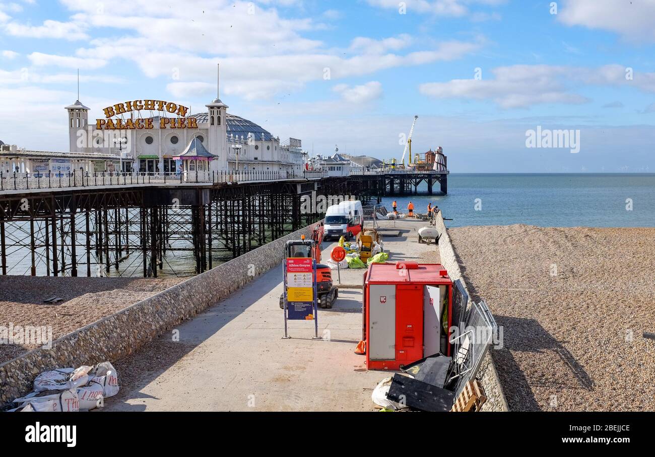 Brighton UK 14th April 2020 - Work continues on repairing the damaged groyne beside the Brighton Palace Pier as lockdown continues in the UK  through the Coronavirus COVID-19 pandemic crisis  . Credit: Simon Dack / Alamy Live News Stock Photo