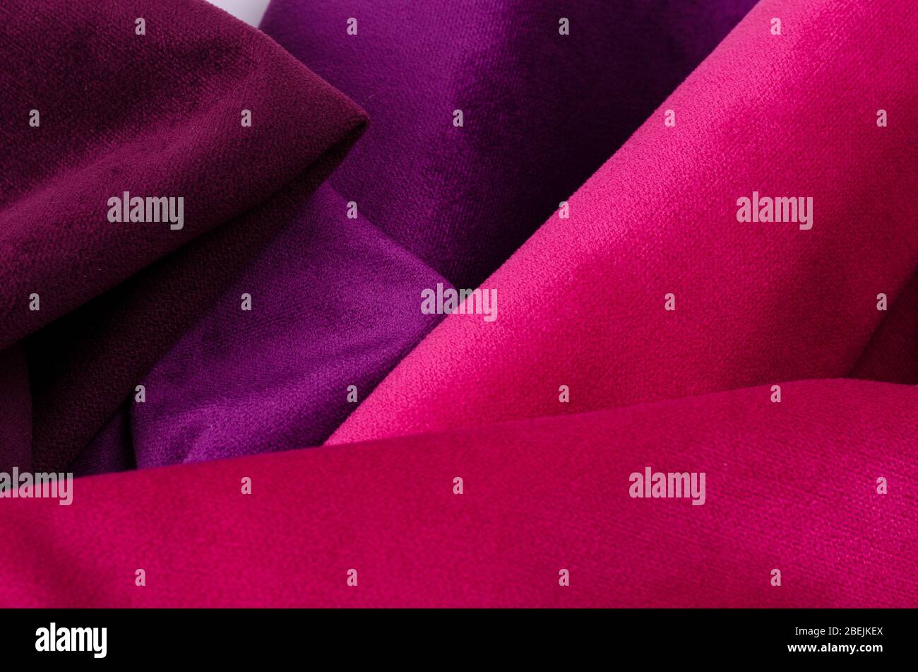 Bright abstract collection of colorful velour textile samples in pink and violet colors. Fabric