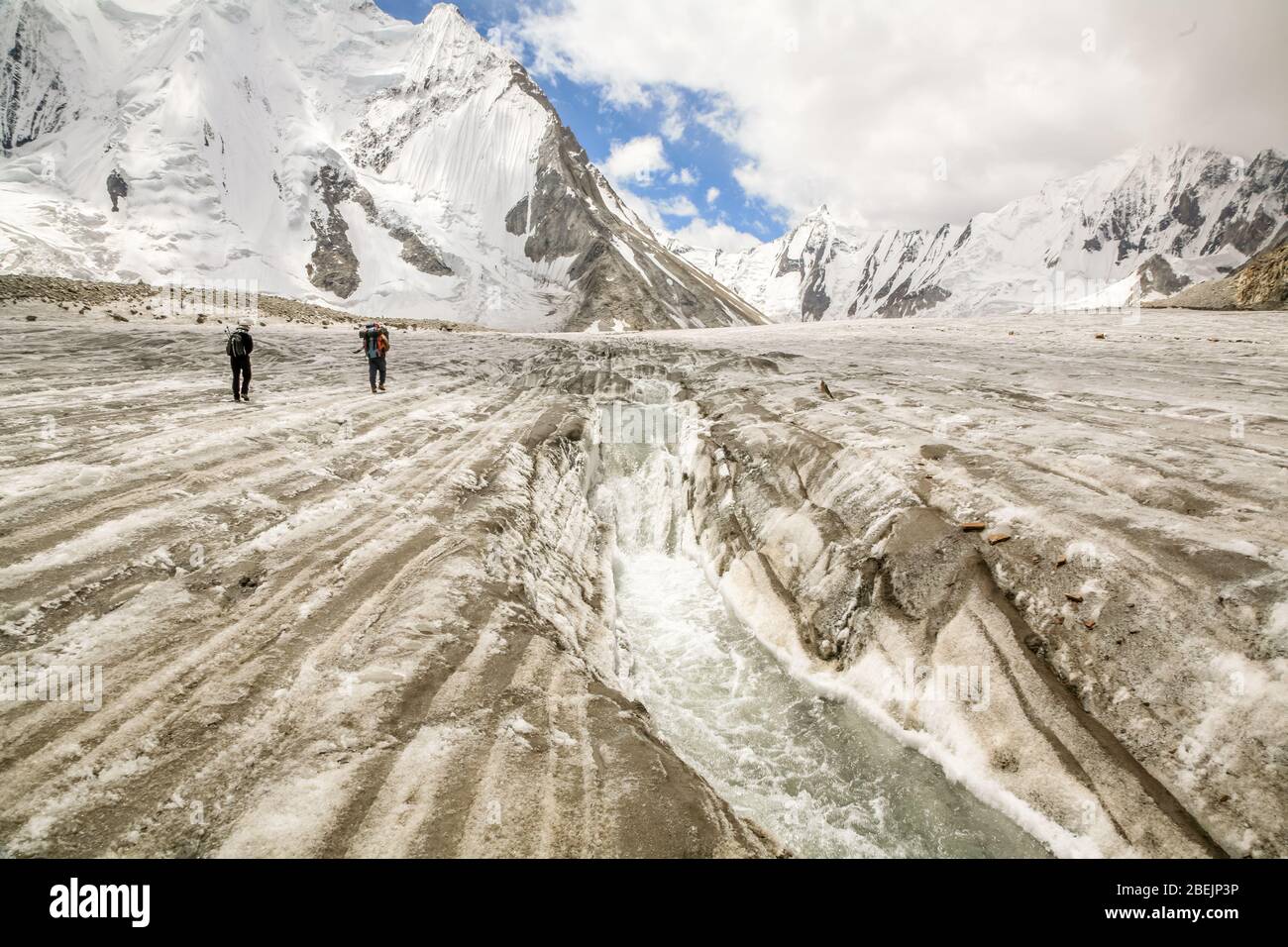 Two hikers on the Vigne Glacier, near the Concordia area of the Karakoram Mountains in Northern Pakistan. Stock Photo