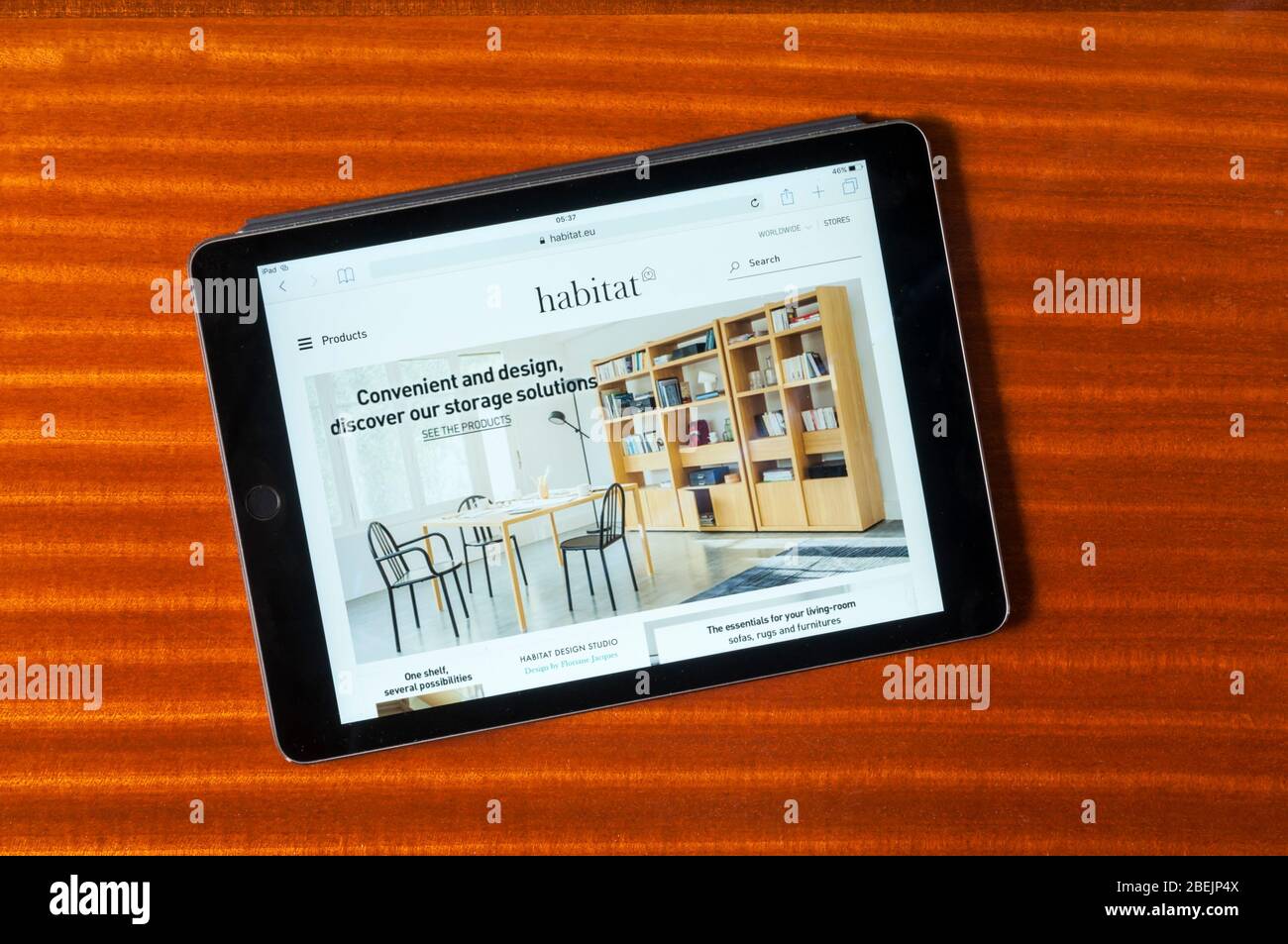 The website of Habitat furniture sellers displayed on an iPad tablet computer against a polished wood background. Stock Photo