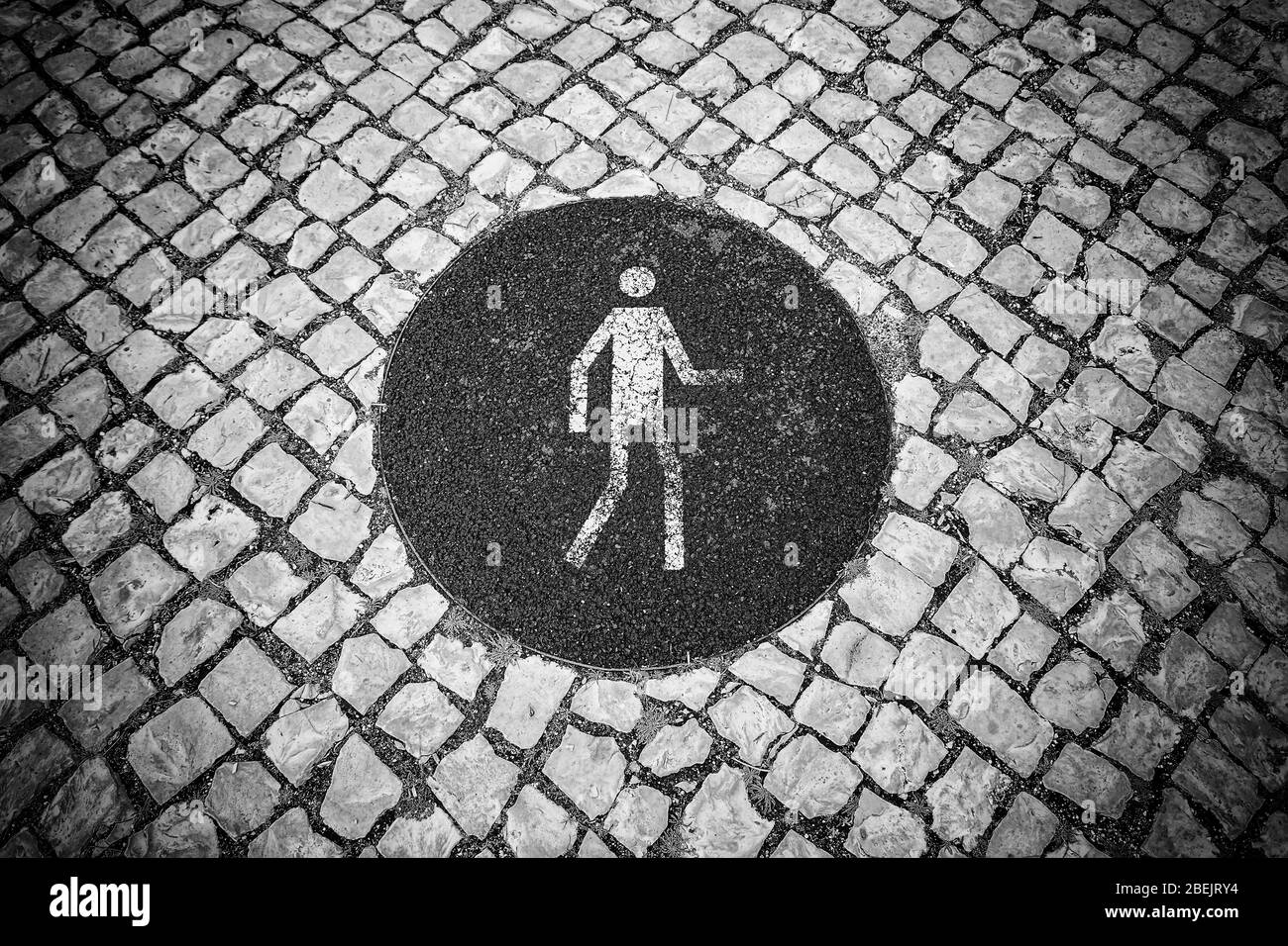 Pedestrian sign on the pavement, detail information signal on a street in Lisbon Stock Photo