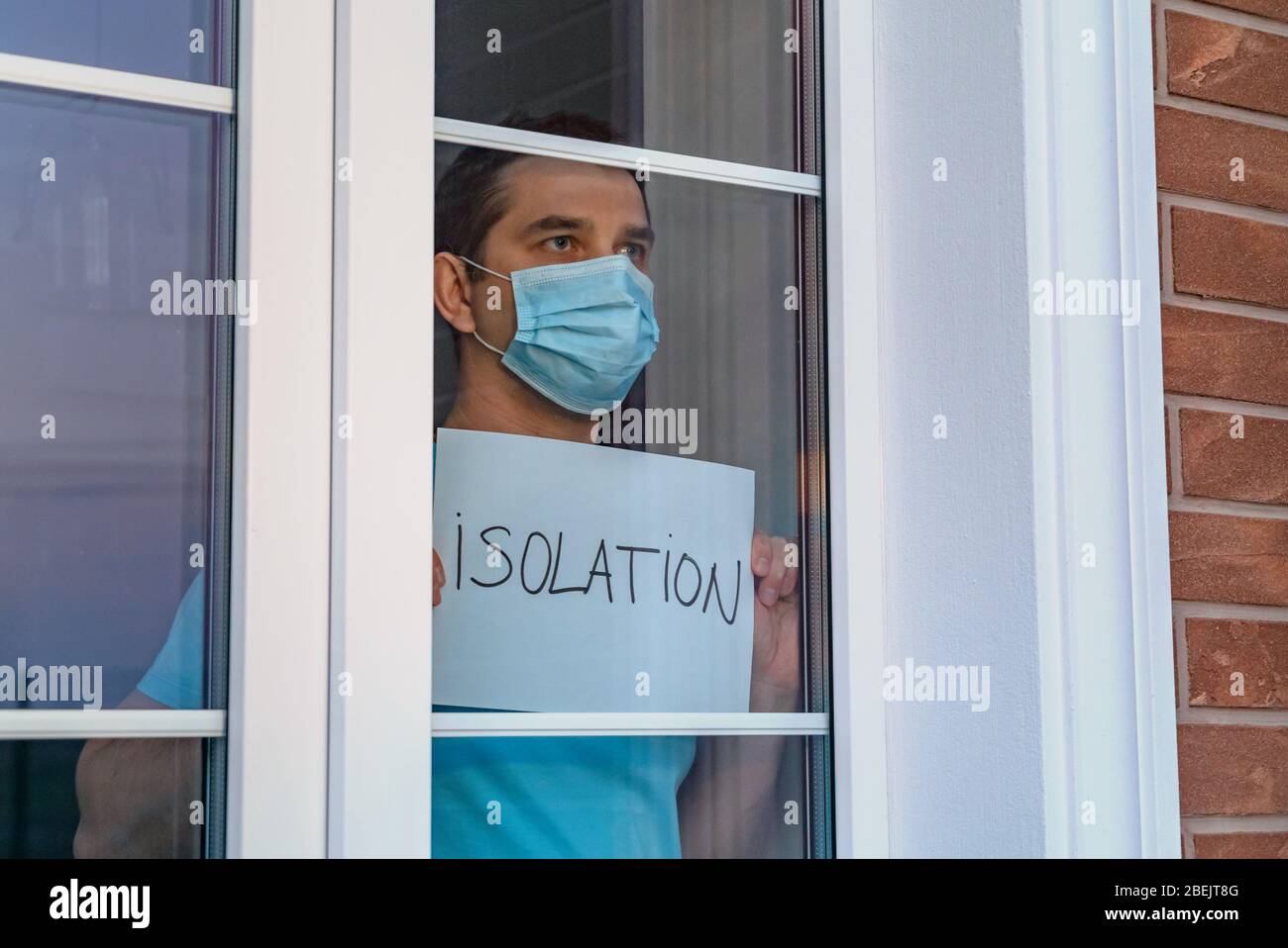 Man in a medical mask holds a tablet - ISOLATION Stock Photo