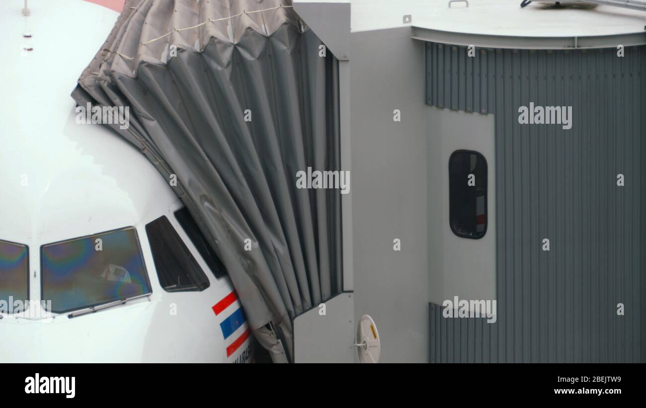Airplane taxiing ends, connect jetbridge Stock Photo