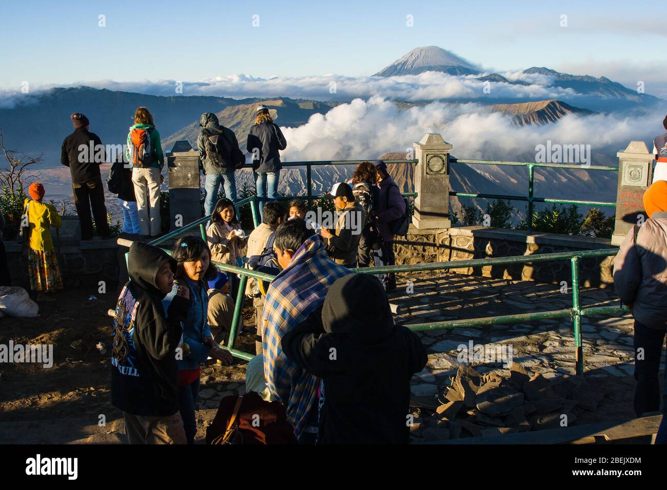 Tourists at the scenic view point overlooking Bromo, Batok and Seremu volcanoes, East Java, Indonesia. Stock Photo